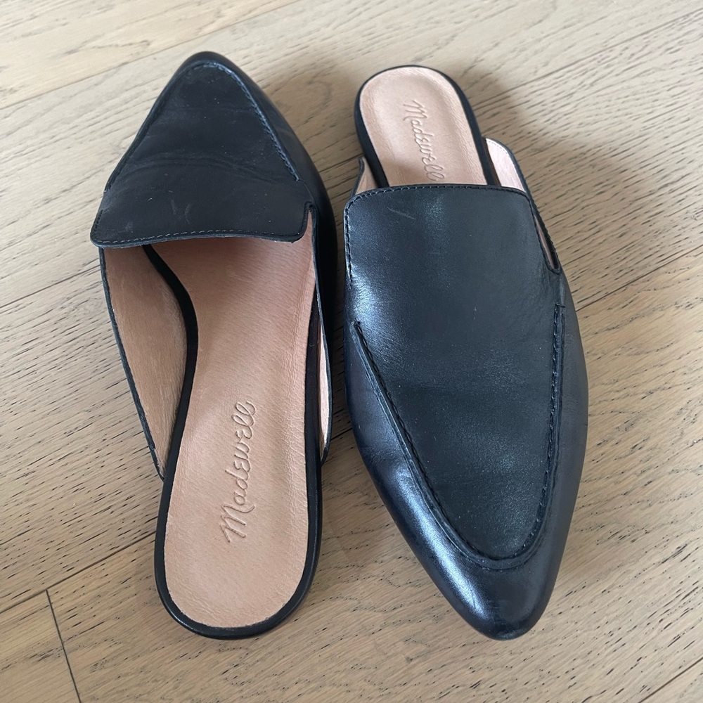 Black pointed flat mules in size 8.5